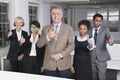 Portrait of multiethnic business group gesturing thumbs up at office Royalty Free Stock Photo