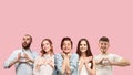 Portrait of multiethnic group of young people isolated on pink studio background, flyer, collage Royalty Free Stock Photo