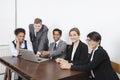 Portrait of multiethnic professionals using laptop at conference room