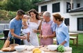 Portrait of multigeneration family outdoors on garden barbecue.