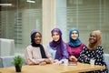 Multiracial group of muslim women dressed in national clothes posing in group