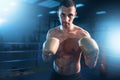 Portrait of muscular boxer in black gloves