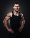 Portrait of a muscular male model against black background