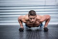 Portrait of muscular man doing push-ups with dumbbells Royalty Free Stock Photo