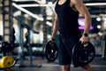 Portrait Of Muscular Man Lifting Barbell Discs While Training At Gym Royalty Free Stock Photo