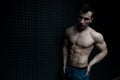 Portrait of Muscular Man Standing Near the Wall Royalty Free Stock Photo