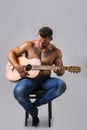 Topless handsome man playing guitar Royalty Free Stock Photo