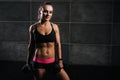 Portrait of muscular sexy young woman posing with two dumbbells Royalty Free Stock Photo
