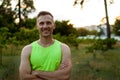 Portrait Muscular Smiling Sportsman In Park At Sunset.