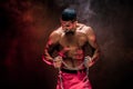 Portrait of muscular sportsman tearing metal chain.Black background. Royalty Free Stock Photo