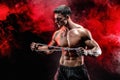 Portrait of muscular sportsman tearing metal chain.Black background. Royalty Free Stock Photo