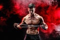 Portrait of muscular sportsman tearing metal chain.Black background. Royalty Free Stock Photo