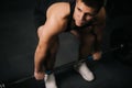 Portrait of Muscular strong man with perfect body wearing sportswear lifting heavy barbell Royalty Free Stock Photo