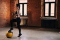 Portrait of muscular young athletic woman with strong beautiful body in sportswear exercising with heavy medicine ball Royalty Free Stock Photo
