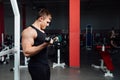 Portrait of a muscular young man lifting weights on gym Royalty Free Stock Photo