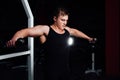 Portrait of a muscular young man lifting weights on gym background. Exercise the shoulders Royalty Free Stock Photo