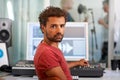 Portrait, music and a man producer in a recording studio mixing audio with a sound desk. Computer, tech or media with a Royalty Free Stock Photo