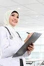 Smiling asian medical doctor in scarf