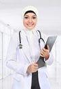 Moslem asian doctor writing on paperclip Royalty Free Stock Photo