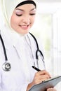 Smiling asian medical doctor in scarf