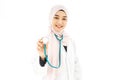 Portrait of muslim asian female Medical doctor showing stethoscope to camera isolated over white background Royalty Free Stock Photo