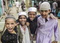 Portrait of Muslim kids making funny faces in the streets of Old Delhi, India.