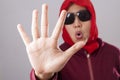 Muslim Lady in Red Shows Stop Gesture Royalty Free Stock Photo