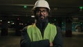 Portrait Muslim man Arabian worker Indian builder posing with crossing hands engineer looking at camera hard hat helmet
