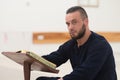 Muslim Man In Dishdasha Is Reading The Quran Royalty Free Stock Photo