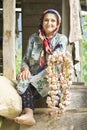 Portrait of a Muslim senior woman having bunch of garlic in hand-vertical shot Royalty Free Stock Photo