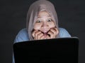 Muslim Woman Terrified Watching Hooror Movie on Streaming Media Royalty Free Stock Photo
