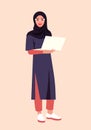 Portrait of a Muslim woman with a laptop. The Arabian student stands at full height.
