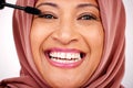 Portrait, Muslim woman and smile with makeup, mascara and cosmetics on a white studio background. Face, Islamic person