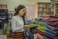 Myanma woman shopping traditional cloting of Amarapura at local weaving fabric shop in Mandalay Myanmar