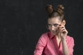 Portrait of mysterious girl with bright makeup in glasses. Young woman in pink shirt on black background. Copy space Royalty Free Stock Photo
