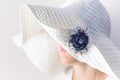 Portrait of a mysterious woman in a white hat with a brooch made of denim handmade Royalty Free Stock Photo