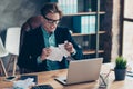 Portrait negative depressed frustrated guy hold hand paper work shred want shout sheets development use user laptop