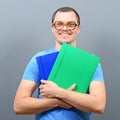 Portrait of a nerd holding books with retro glasses Royalty Free Stock Photo