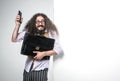 Portrait of a nerdy guy holding a briefcase and a cell phone Royalty Free Stock Photo