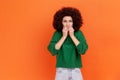 Portrait of nervous stressed woman with Afro hairstyle wearing green casual style sweater standing