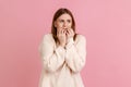 Young adult blond woman thinking and worried about work, deadlines and biting her nails. Royalty Free Stock Photo