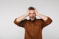 Portrait of nervous young man with headache grabbing her head Royalty Free Stock Photo