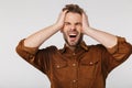 Portrait of nervous young man with headache grabbing her head Royalty Free Stock Photo