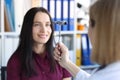 Neurologist doctor driving hammer tool in front of patient eyes in clinic