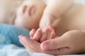 Portrait of newborn Asian baby boy sleep on the bed , cute selective hand foot feet fingers Royalty Free Stock Photo