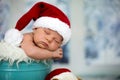 Portrait of a newborn baby boy,l wearing christmas hat, sleeping Royalty Free Stock Photo