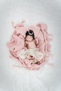 Portrait of newborn baby boy lying in a basket with silver crown. Royalty Free Stock Photo