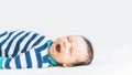 portrait of Newborn baby boy yawns lying on bed, peacefully sleeping, close up Royalty Free Stock Photo