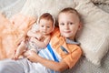 Portrait of newborn baby girl and elder brother. Young boy lying with newborn sister Royalty Free Stock Photo