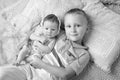 Portrait of newborn baby girl and elder brother. Young boy lying with newborn sister Royalty Free Stock Photo